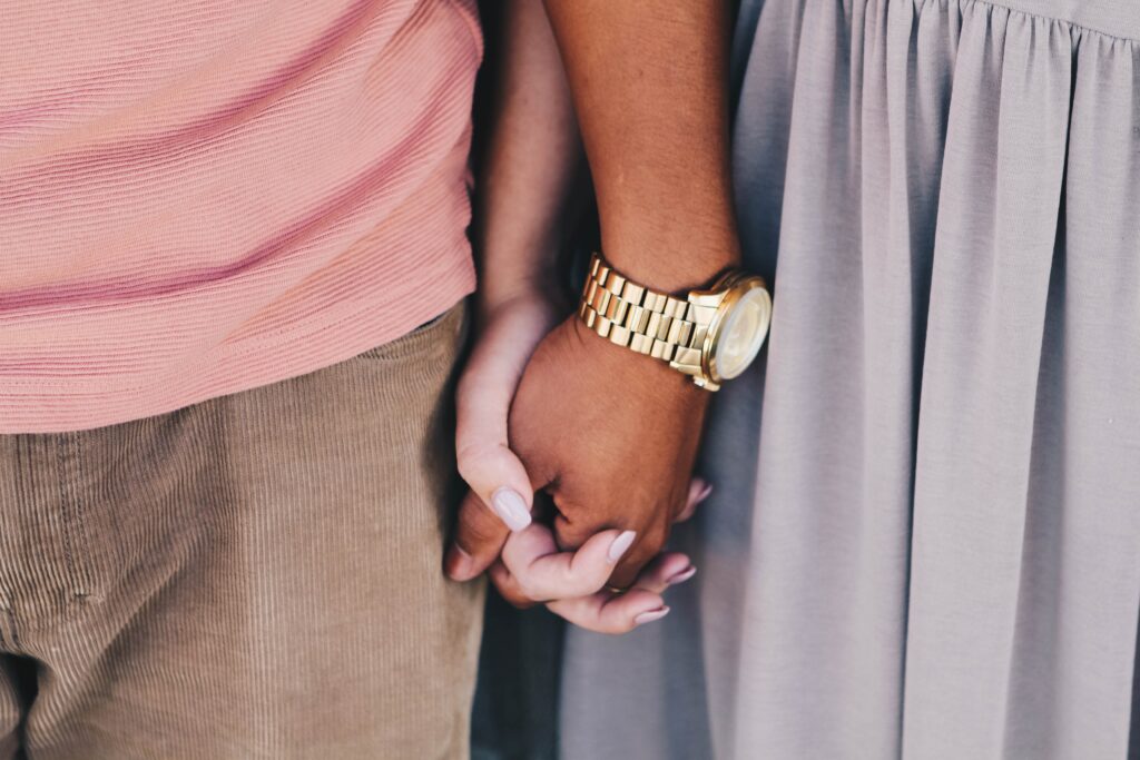 Interracial couple holding hands.