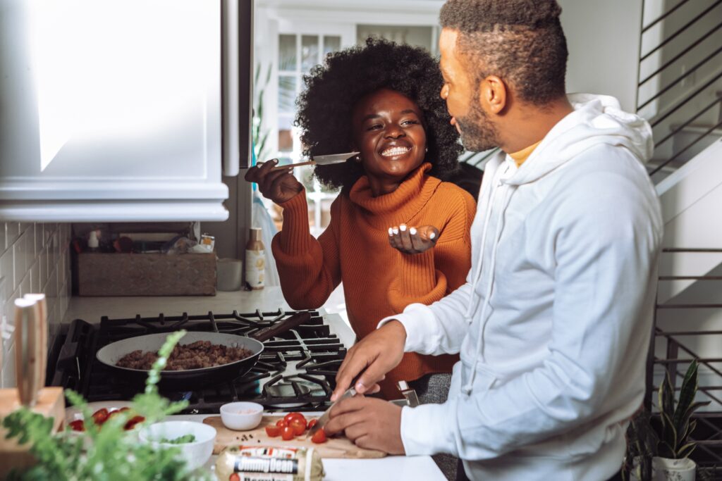 Happy couple cooking a meal together