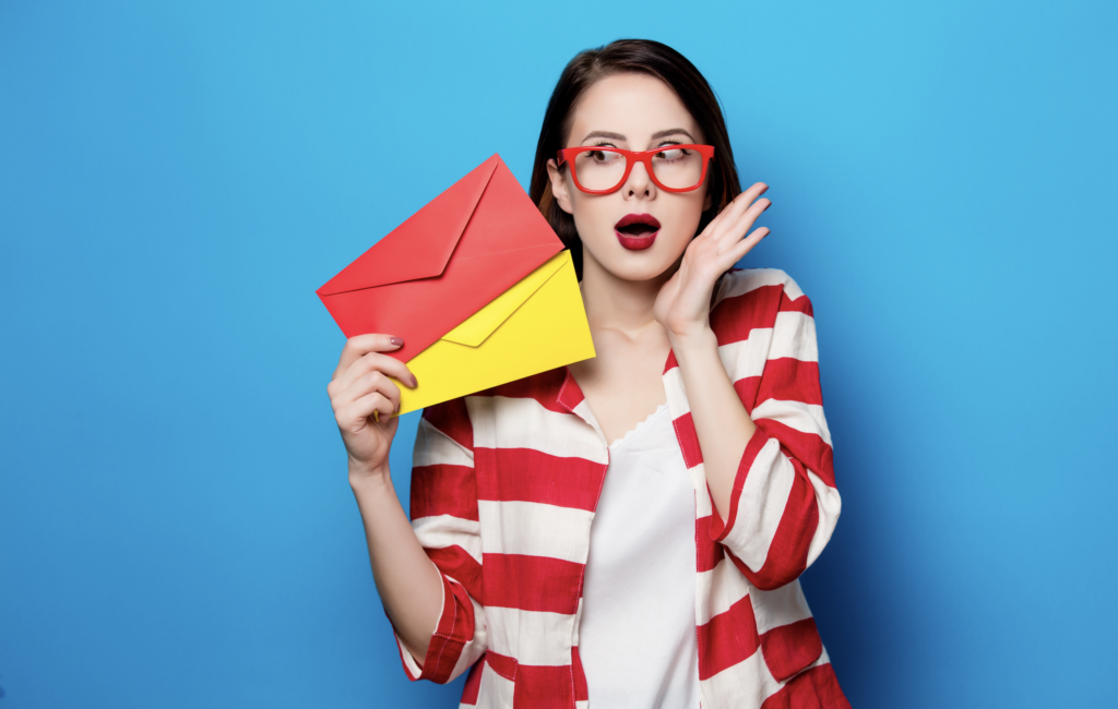 Image of a woman with mail envelopes standing in front of a blue backdrop