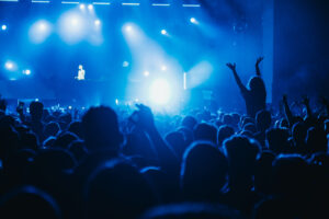 People in a crowd of a music concert having fun while listening their favorite artist. Youth and celebration concept. Music festival concept.